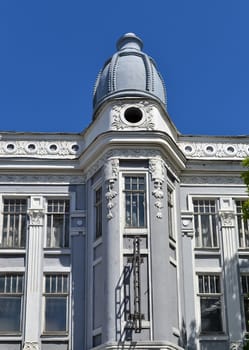 Beautiful building with stucco mouldings and dome, in Ulyanovsk, Russia. The fragment on the background of blue sky.