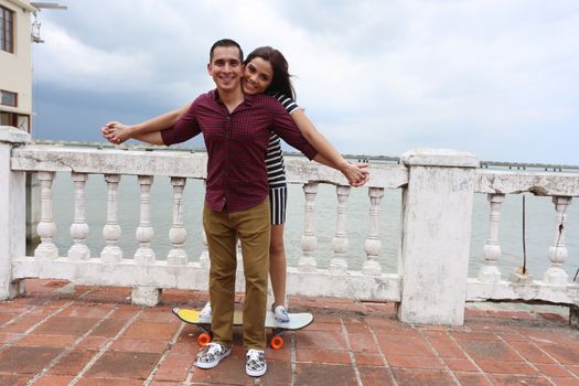 Laughing hipster couple hanging out together and enjoying it entirely.