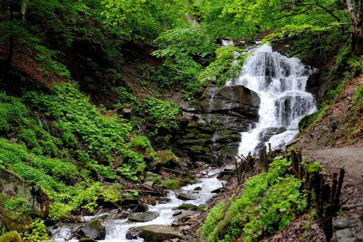 Waterfall in forest. In the deep forest on mountain