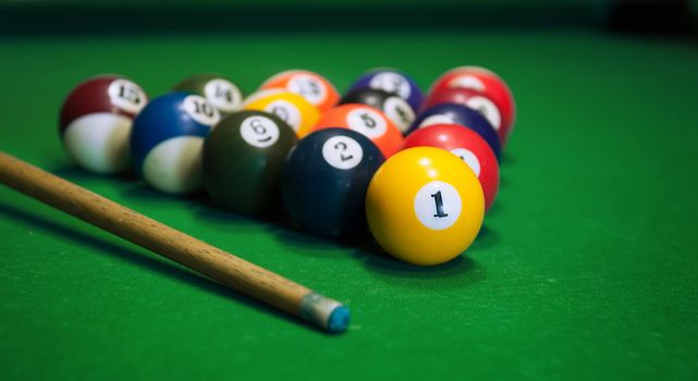 Billiard balls in a green pool table