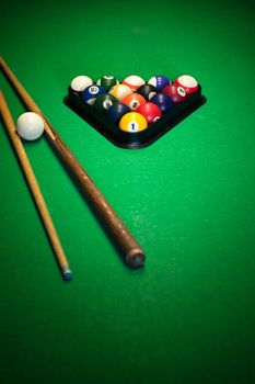 Billiard balls in a green pool table