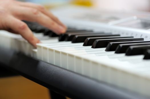 Defocusing hands on the keyboard of the piano