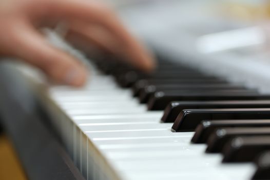 Defocusing hands on the keyboard of the piano