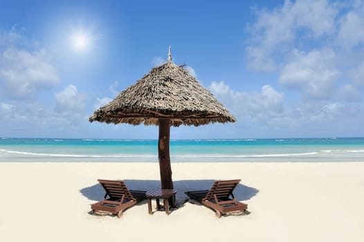 Beautiful tropical beach witn straw umbrella. Straw umbrella at the beach