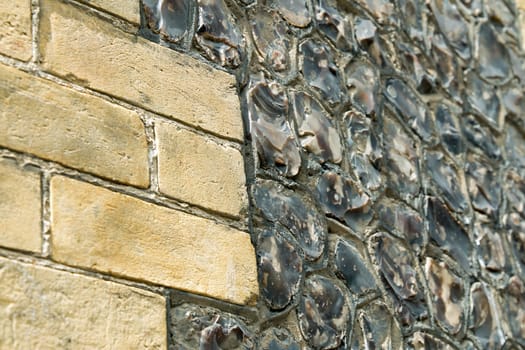 Sussex house wall made of sandstone brick and random snapped field flints.