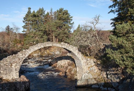 The Old Packhorse Bridge in Carrbridge, Inverness-shire in Scotland. The oldest packhorse bridge in the Highalnds, built in 1717, and spans the River Dulnain.