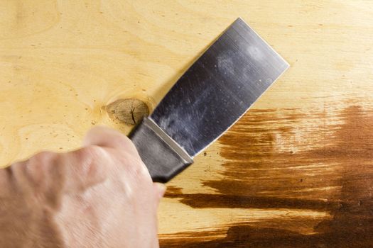 New metal spatula on the wooden background