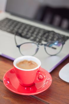 Red coffee cup on work station, stock photo