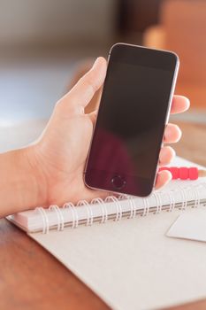 Smart phone in a woman's hand, stock photo