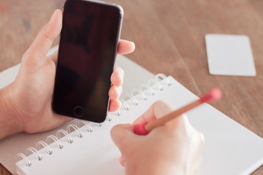 Smart phone in a woman's hand, stock photo