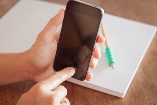 Smart phone in a woman's hand, stock photo