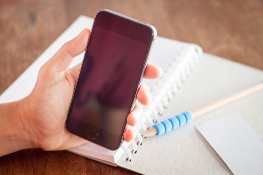 Smart phone in a woman's hand, stock photo