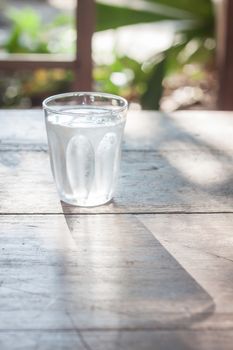 Glass of cold water on wooden table, stock photo