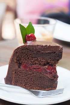 Piece of chocolate cake on white plate, stock photo