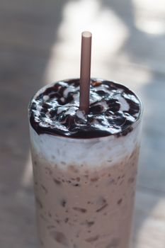 Glass of iced coffee on wooden table, stock photo