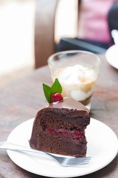 Piece of chocolate cake on white plate, stock photo