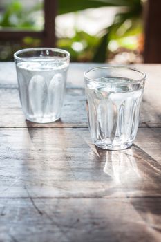 Glasses of cold water on wooden table, stock photo