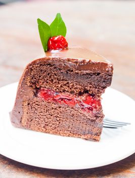 Piece of chocolate cake on white plate, stock photo
