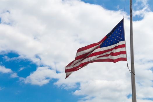 American flag waving in the wind. Intense cloudy sky in the background.