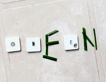 A close view of some keys on a dirty, yellowed keyboard.text green