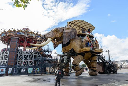 NANTES, FRANCE - CIRCA SEPTEMBER 2015: The Great Elephant goes for a walk with passengers aboard.