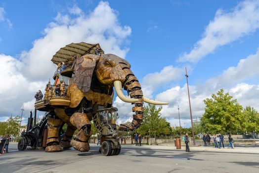 NANTES, FRANCE - CIRCA SEPTEMBER 2015: The Great Elephant goes for a walk with passengers aboard.