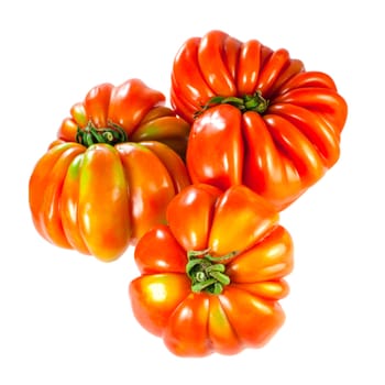 three fresh tomatoes, closeup on white background, selective focus