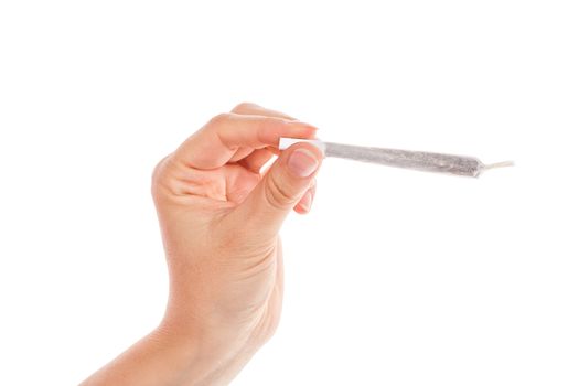 Female hand holding cannabis joint isolated on white background. Medical marijuana.