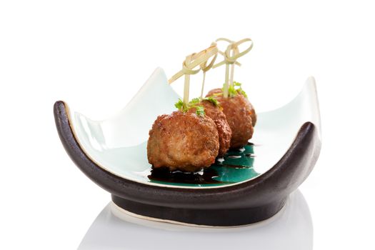 Meatballs canape on ceramic tray isolated on white background. Culinary bbq eating. 