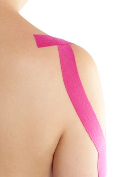 Kinesio tape on shoulder on beautiful caucasian woman. Alternative medicine, rehabilitation. 