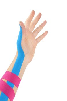 Kinesio tape on female hand isolated on white background. Chronic pain, alternative medicine. Rehabilitation and physiotherapy.