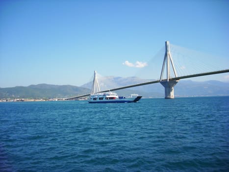 the largest bridge Rio-Antirio in Greece. Ship transports people and cars.