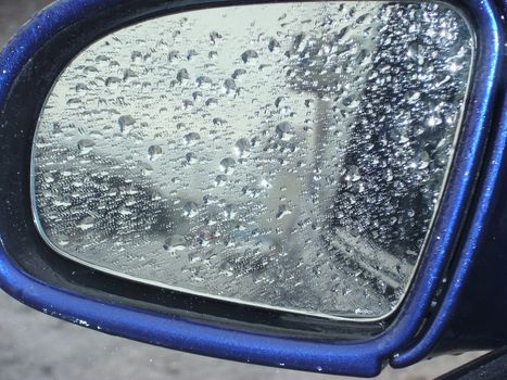 heavy rain raindrops on the car mirror