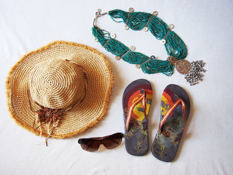 a good plot for a beach site hat sandals sunglasses jewelery