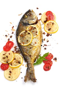 roasted fish  Dorado with lemon slices and tomatoes flavored   spices