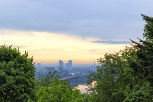 Sunrise in Kiev Botanical Garden overlooking the left bank of the Dnieper river reflecting in water