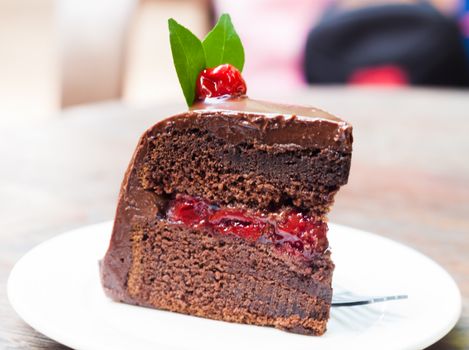 Piece of chocolate cake on white plate, stock photo