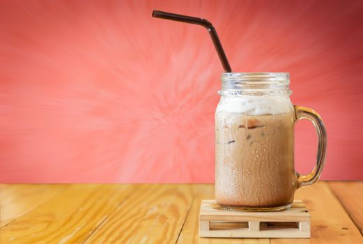 Close up iced coffee on wood table with blurred background