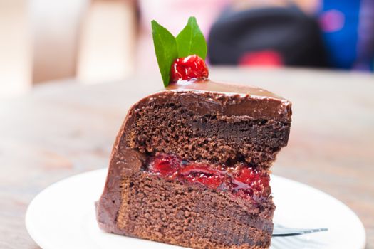 Piece of chocolate cake on white plate, stock photo