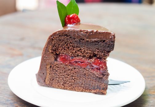 Piece of chocolate cake on white plate, stock photo