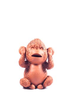 Close-up monkey clay doll isolated on white background, stock photo