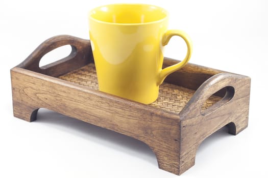 Brown mug on wooden tray isolated on white background, stock photo