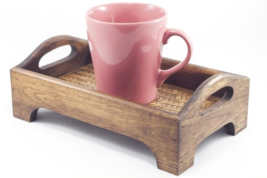 Brown mug on wooden tray isolated on white background, stock photo