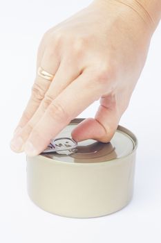 Close-up tin can with hand isolated on white background, stock photo