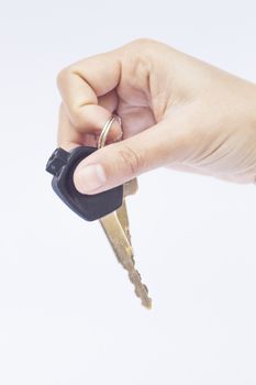 Hand with a car key isolated on white background, stock photo