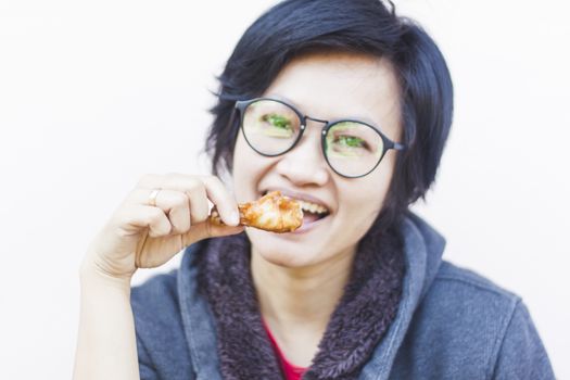 Asian woman eating delicious chicken, stock photo