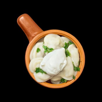Dumplings with greens and sour cream in a ceramic bowl isolated on black background