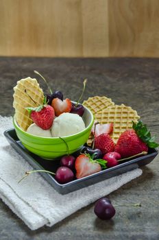 Vanilla ice cream scoops with fresh berries fruit