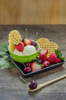 Vanilla ice cream scoops with fresh berries fruit