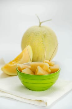 Ripe melon with slice on white background